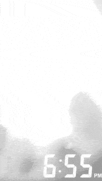 a black and white photo of a pot of soup with 6:55 pm on the bottom