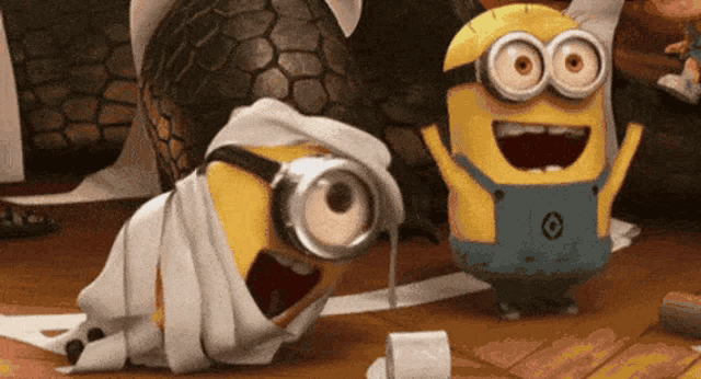 two minions from despicable me are playing with toilet paper