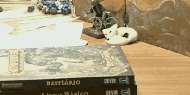 a stack of bestiario books sit on a table