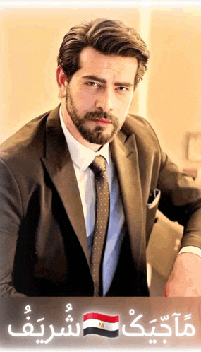 a man in a suit and tie is leaning against a wall