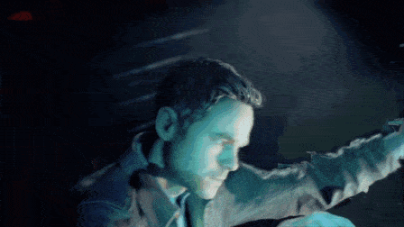 a man in a suit and tie is looking at something in the dark