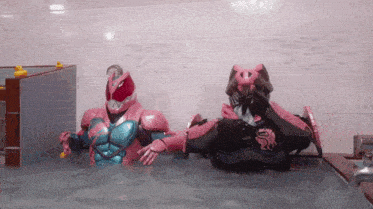 two superhero figures are in a bathtub with rubber ducks on the wall
