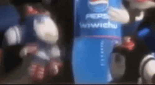 a close up of a bottle of pepsi with a cartoon character behind it .