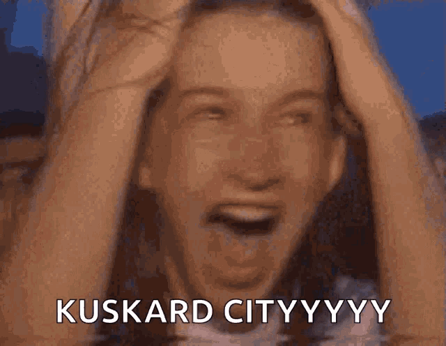 a woman is covering her mouth with her hands and the words kuskard cityyyy are visible