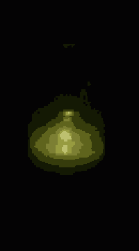 a candle is lit up in the dark with a blurred background .