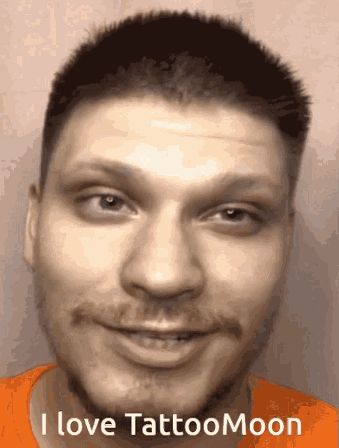 a close up of a man 's face with the words " i love tattoomoon " on the bottom