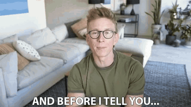 a man wearing glasses says " and before i tell you " in a living room