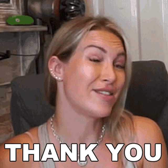 a woman is sitting in a chair with her eyes closed and a thank you message on her face .