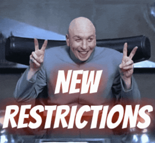 a bald man is giving a peace sign in front of a sign that says " new restrictions "