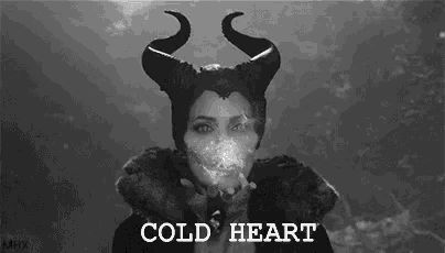 a woman with horns blowing smoke in a black and white photo with the words `` cold heart '' .