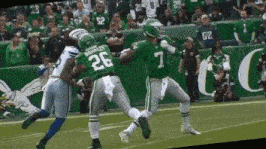 a football player with the number 7 on his jersey is being tackled by another player
