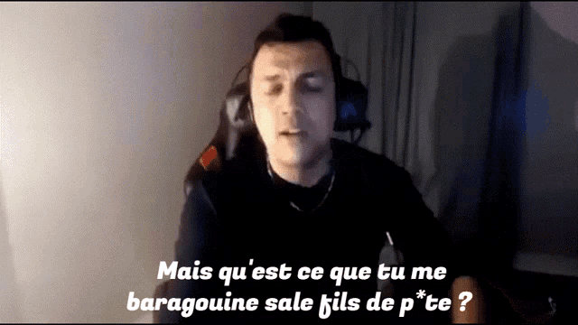 a man wearing headphones and a microphone says mais qu ' est ce que tu me baragouine sale fils de p * te