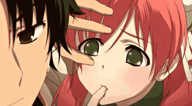 a girl with red hair is being touched by a man with black hair