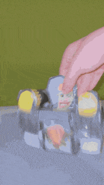 a close up of a person 's hand reaching into a can of soda