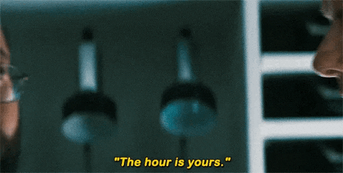 a close up of a person 's face with the words `` the hour is yours '' written on it .