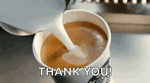 a cup of coffee with milk being poured into it and the words thank you written on the bottom