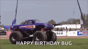 a monster truck says happy birthday bug in front of a crowd of people