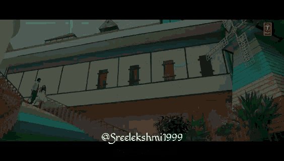 a man and a woman are walking down stairs in front of a building that says sreelakshmi1999