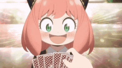 a girl with pink hair and green eyes is holding a bunch of cards in her hand .