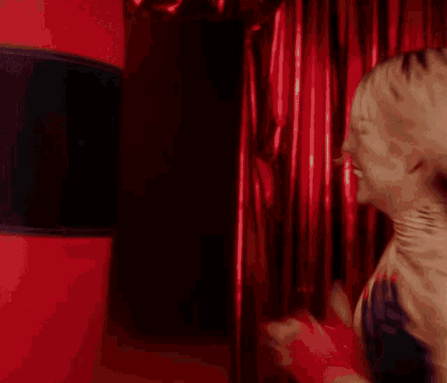 a woman is punching a red punching bag