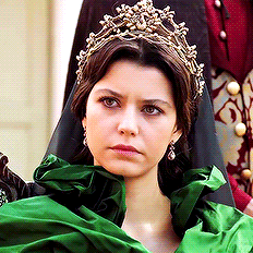 a woman is wearing a tiara and a green dress