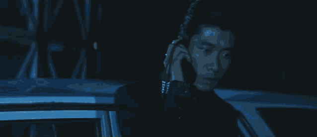 a car is parked in a dark room with a blue light shining on it .