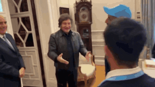 a man wearing a blue hat is talking to another man