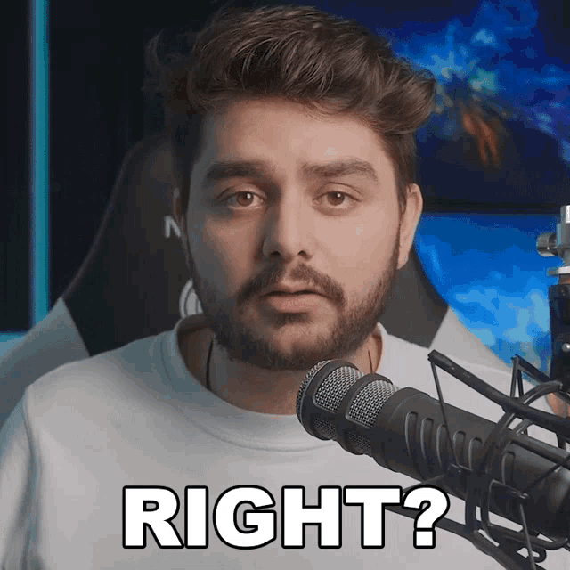 a man with a beard stands in front of a microphone saying right