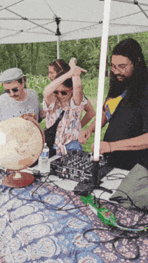 a group of people standing around a table with a globe