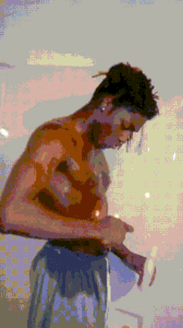 a pixelated image of a shirtless man with a ponytail