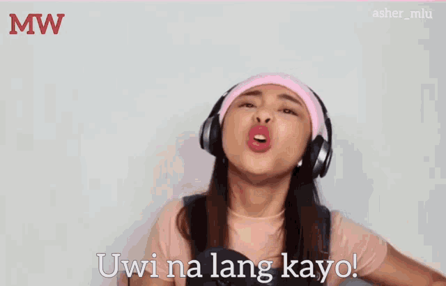 a woman wearing headphones and a pink headband says uwina lang kayo