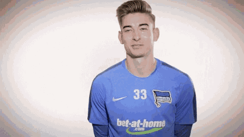 a man wearing a blue jersey that says bet-at-home.com