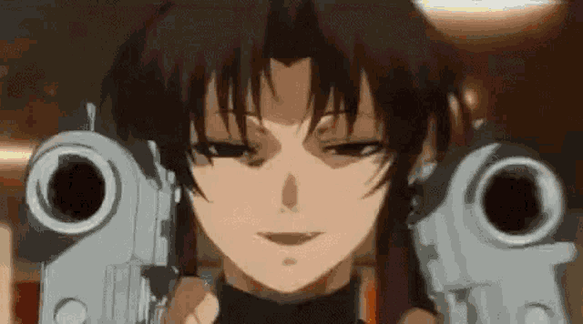 a close up of a girl holding two guns in front of her face .