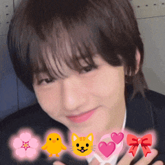 a close up of a person 's face with a cat a chick and a flower in the background