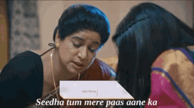 two women are sitting next to each other with the words seedha tum mere paas aane ka