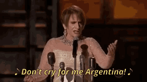 a woman is singing into a microphone and saying `` do n't cry for me argentina ! ''