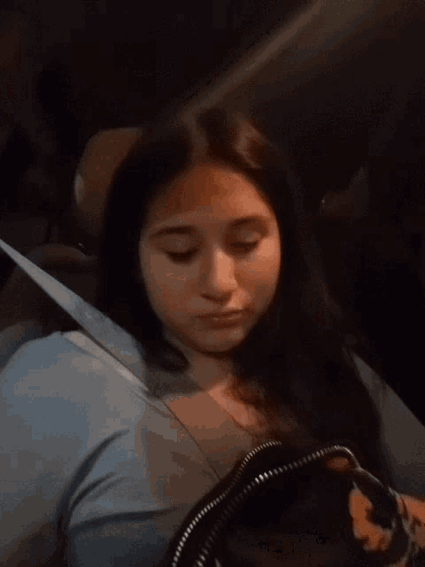 a girl giving the middle finger while sitting in a car