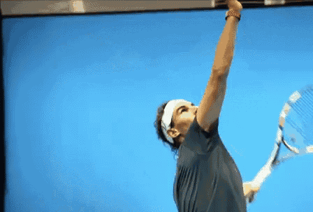 a man is holding a tennis racquet in his hand