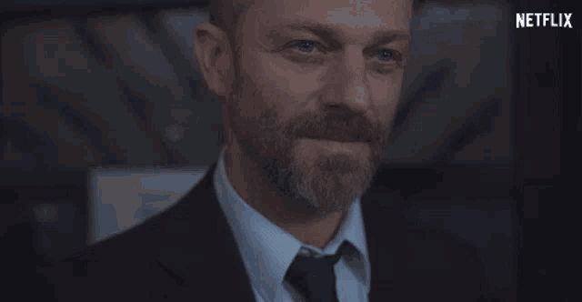a close up of a man 's face with the netflix logo in the corner