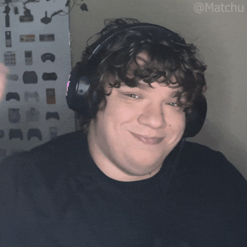 a man with curly hair wearing headphones with the hashtag matchu on the bottom right