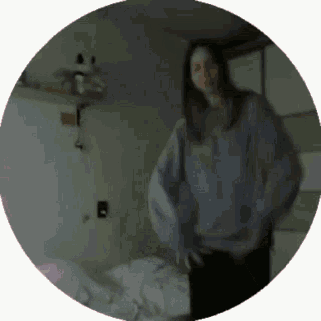 a blurry picture of a woman in a blue sweater