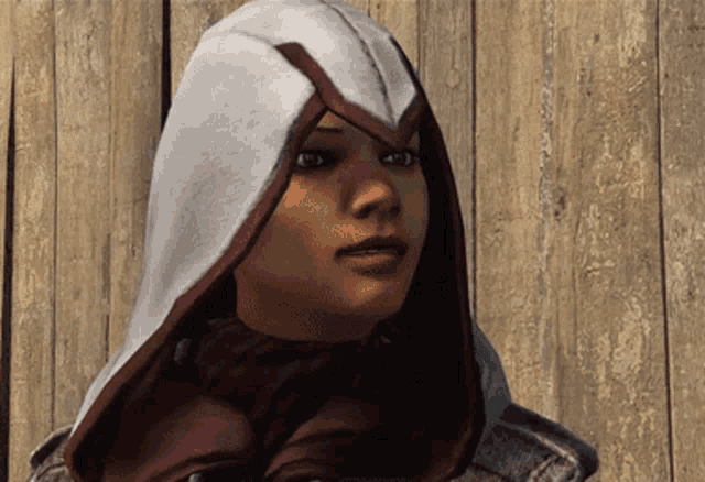 a woman with a hood on her head looks to the side