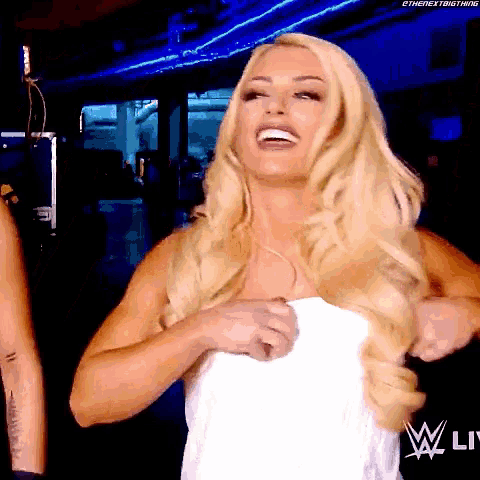 a woman in a white towel is smiling in front of a w live logo