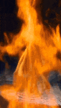 a close up of a volcano with flames coming out of it