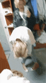 a woman is taking a picture of herself in the mirror