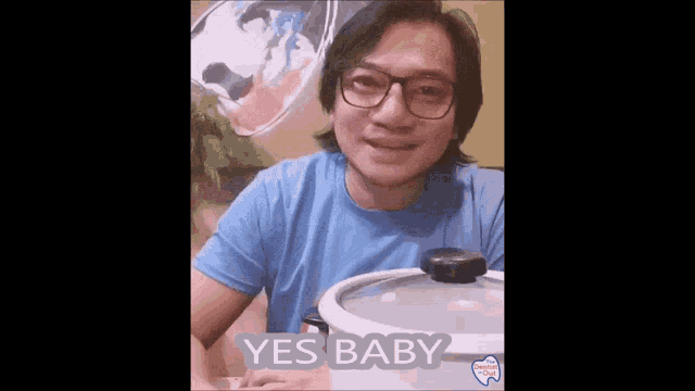 a man wearing glasses is holding a pot with the words yes baby written on it