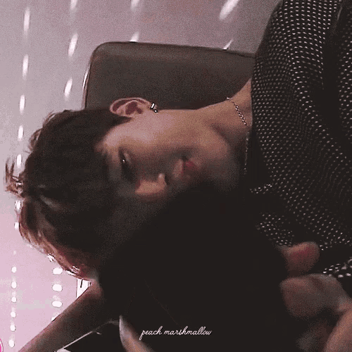 a close up of a person laying down with peach marshmallow written on the bottom right