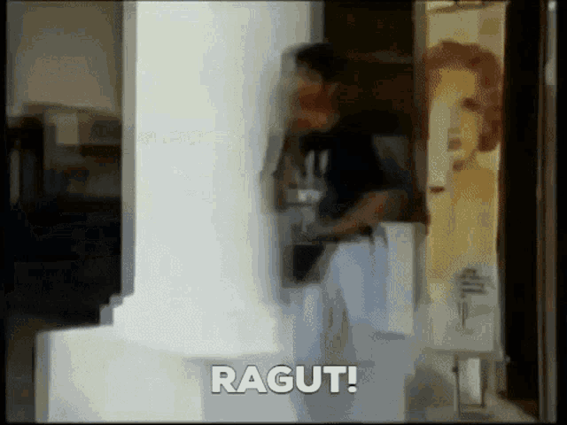 a blurry picture of a man standing next to a white pillar with the words " ragut " on the bottom