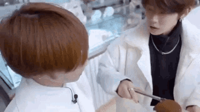 a man is cutting a piece of cake with a knife .
