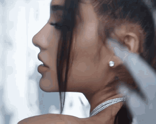 a close up of a woman 's face with earrings on